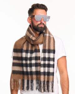 A folded navy tartan cashmere scarf.