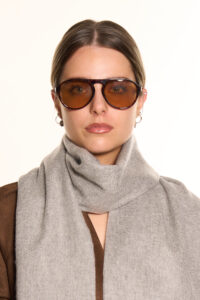 A close-up of the delicate work on a charcoal cashmere scarf, showing the density of the 140g weave.