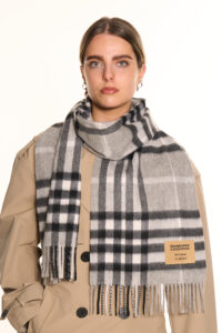 A navy cashmere scarf displayed in an elegant handcrafted box