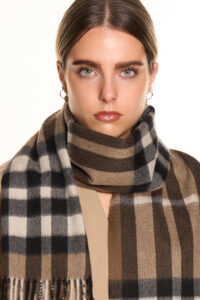 A navy plaid cashmere scarf in a handcrafted gift box.
