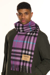 A couple sharing a cosy winter moment, each wearing an Scott Cashmere scarf
