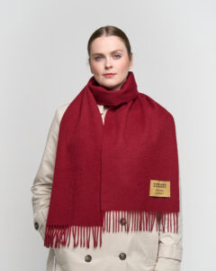 A folded red tartan cashmere scarf.