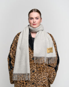 A beige cashmere scarf elegantly displayed in a premium gift box.