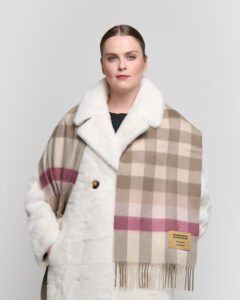 A grey cashmere scarf elegantly folded in a signature box.