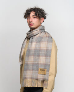 Neutral-toned cashmere scarves arranged in a luxury boutique setting